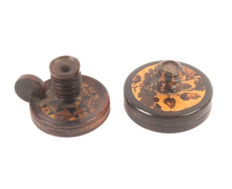 An unusual Tunbridge ware rosewood seal box and a miniature chamber stick, the first of circular form, the screw top with a c