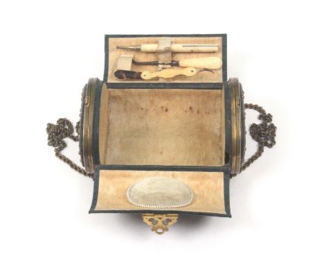 A French handbag form sewing companion for a child, circa 1880, of oval section covered in crosss-hatched green leather with 