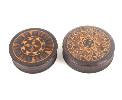 Two Tunbridge ware rosewood circular boxes, one with stick ware top, 6cms dia., the other with geometric mosaic panel, 6.5cms