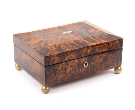 A fine burr wood Palais Royal sewing box, circa 1810, of rectangular form raised on wooden gilt ball feet, oval mother of pea