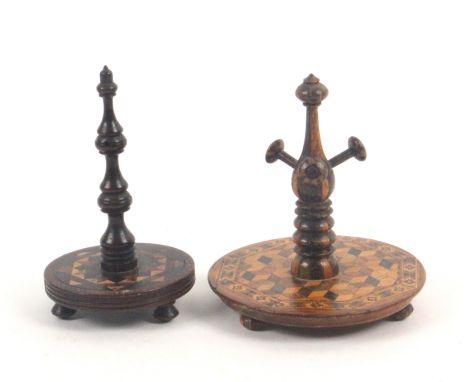 Two Tunbridge ware ring stands, the first raised on three stick ware bun feet, the circular base in cube work within a geomet