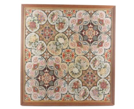 An elaborate Victorian wool work tapestry panel, worked with geometric panels within panels of flowers, the colours fresh, gl