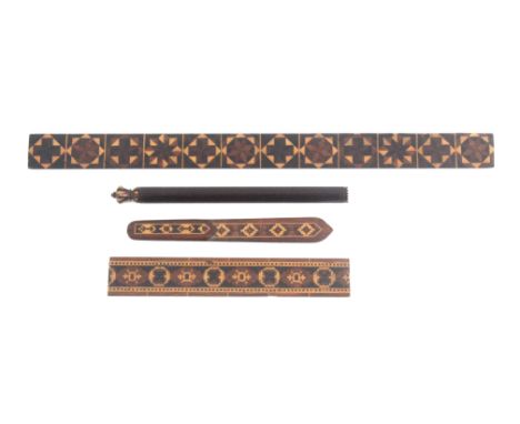 Four Tunbridge ware desk requisites, comprising a ruler divided by twelve stick ware panels, 30.5cms, a rosewood ruler in geo