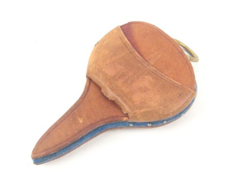 A small leather sewing companion for a child or doll, circa 1880, of scissor shape, one side with a pair of steel scissors wi