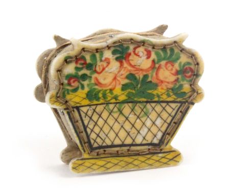 An attractive painted bone pin cushion in the form of a basket of flowers, 4.2 x 3.5cms.                                     