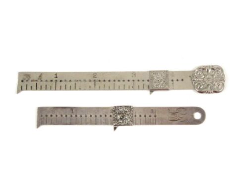 Two American white metal hem measures, one stamped 'Sterling' and initialled 'LP', 11cms, the other stamped 'Pelouze Scale an