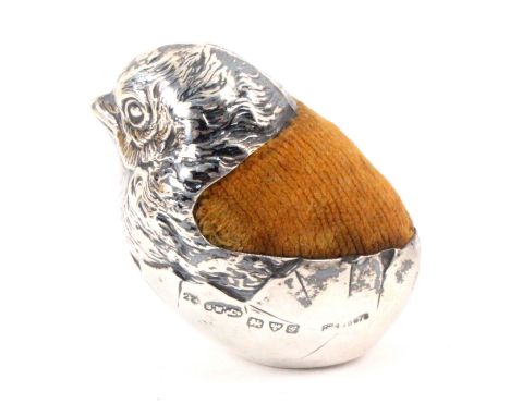 A silver figural pin cushion in the form of a chick emerging from an egg, Chester 1907 by Sampson Mordan and Co., Rd. 47567 ?