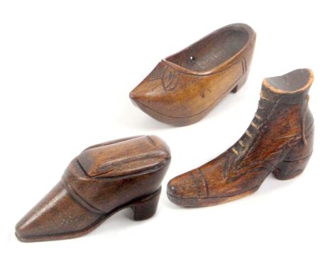 An early 19th Century mahogany shoe snuff box and two other wooden shoes, the snuff box with brass pin decoration to sole, to