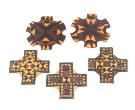 Five Tunbridge ware thread winders, in stick ware comprising a circular pair, 4cms, and a set of three cross form examples, 3