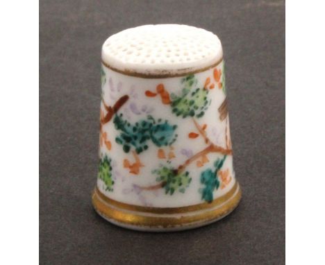 An early 19th Century porcelain thimble, probably Worcester, painted with a robin perched on and amid leafy branches between 