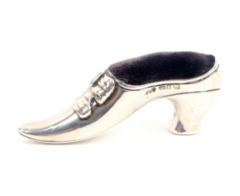 A silver pin cushion in the form of a lady's shoe, with 'ribbon' laces, Birmingham 1891, makers mark indistinct, 6.5cms wide,