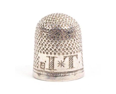 A 17th Century English silver thimble, with a reserved plain rectangular panel with large scratch inscribed initials 'IT' div