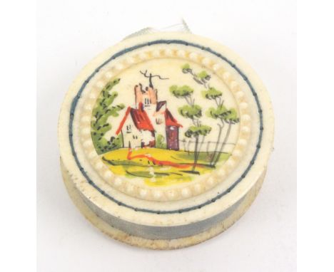 A painted bone disc form pin cushion, one side painted with flowers and inscribed 'A Trifle from Brighton', the reverse with 