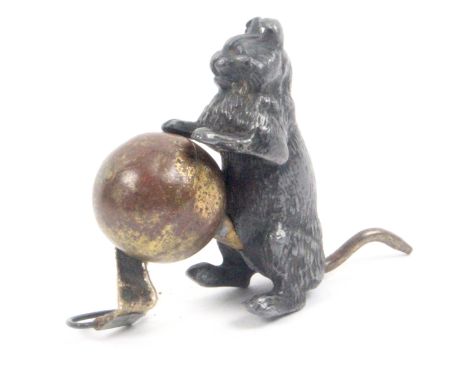 A novelty tape measure in the form of cast metal Louis Wain style cat, standing on a brass ball, the complete but grubby tape