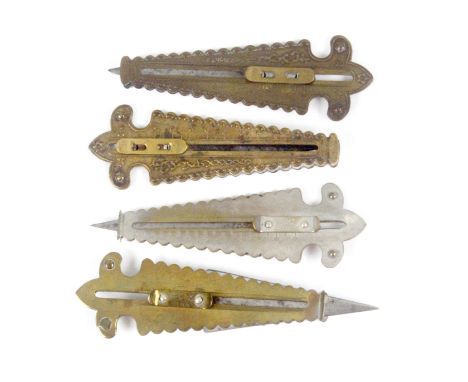 Four fancy brass and plated button hole cutters, each of tapering form, two stamped for 'D.M. Co' two for 'Webster Mfg. Co', 