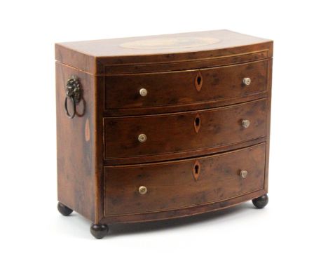 An early Tunbridge ware line inlaid and print decorated yew wood sewing box in the form of a three drawer miniature bow front