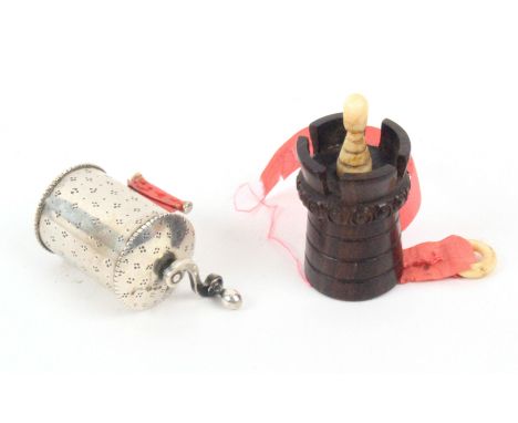 Two tape measures, comprising a good Dutch silver example with dot decorated cylinder body and domed ends below a coffee grin
