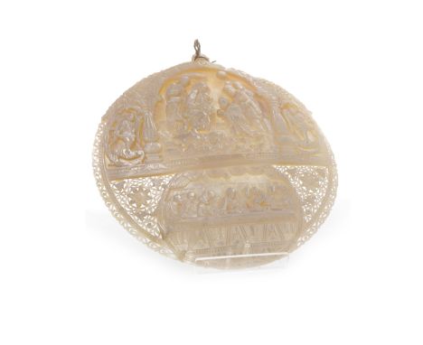 LATE 19TH CENTURY MOTHER OF PEARL CARVED SHELL of oval form, the top section carved in high relief with the Nativity scene, t