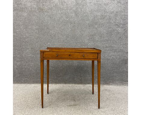 A George III satinwood side table, the top having a central marquetry inlaid paterae with an ebony dentil patterned border al