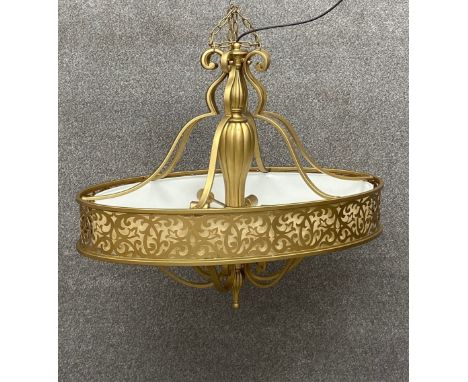 A contemporary brass carabel pendant light or chandelier having a central reeded column with six scrolling branches holding a