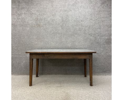 A mid 20th century industrial style dining table or work bench having a stainless steel sheet metal top over a welded and riv