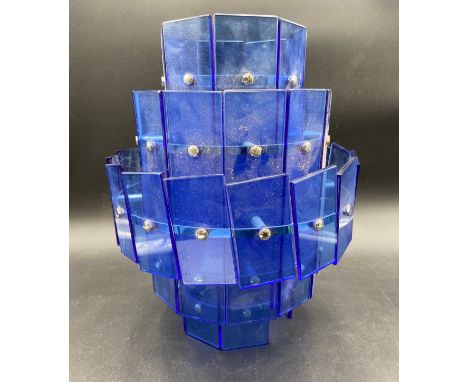 A mid-century Art Deco style pendant light having a stepped and faceted waterfall of applied rectangular blue glass panels fi