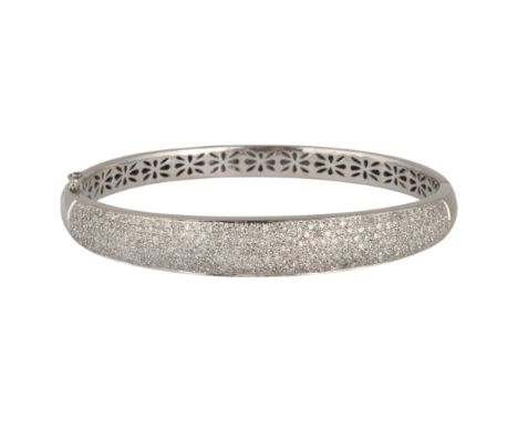 A 9ct white gold diamond hinged bangle, pave set with single-cut diamonds, total diamond content approx 2.5ct, setting height