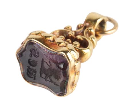 An Antique Victorian 15ct gold amethyst seal fob, circa 1860, the shield foil-back amethyst matrix intaglio carved with crest