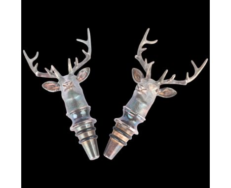 ASPREY - a pair of Elizabeth II cast sterling silver stag-head bottle stoppers, London 2012, with glass eyes, 12cm, RRP £1,25