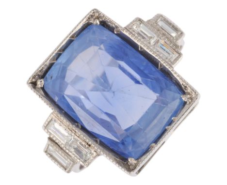 A Sri Lankan no heat sapphire and diamond ring, rectangular millegrain set with 7.5ct cushion-cut sapphire flanked by 6 bague
