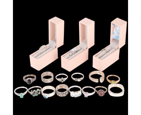 A quantity of silver rings, including dimonique and opal . Condition Report:Lot sold as seen unless specific item(s) specifie