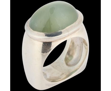 A heavy sterling silver prehnite abstract ring, rub-over set with oval cabochon prehnite and square flat bottom shank, settin