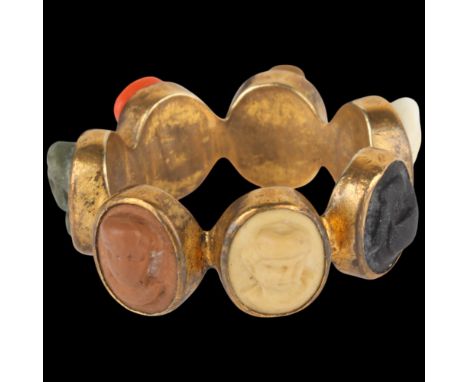 A Grand Tour vari-hue lava cameo full eternity ring, setting height 9.1mm, size K, 3.4g . Condition Report:Cameos are quite h