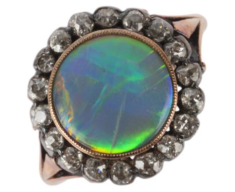 An Antique 18ct gold opal and diamond cluster ring, rub-over set with round low cabochon opal surrounded by collet set old-cu