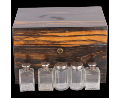 A 19th century coromandel travelling dressing case, with 5 silver-mounted glass toilet jars and leather-fitted interior . Con