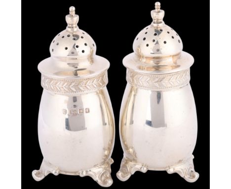 A pair of George V silver pepperettes, Blackmore & Fletcher Ltd, London 1924 and 1925, 8cm, 3.4oz total . Condition Report:No
