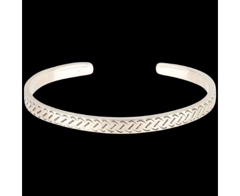 A sterling silver cuff bangle, maker HJ, engraved decoration, band width 5.5mm, internal circumference 18cm, 22.4g . Conditio