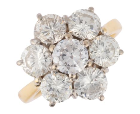 An 18ct gold seven stone diamond flowerhead cluster ring, London 1995, claw set with modern round brilliant-cut diamonds, tot