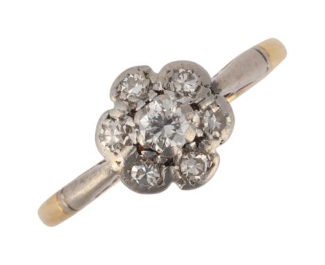 An 18ct gold diamond flowerhead cluster ring, platinum-topped set with round-cut diamonds, unmarked mount tests as 18ct, sett