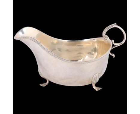 A George V silver sauce boat, Mappin & Webb, Birmingham 1910, length 14cm, 3.2oz . Condition Report:All feet are pushed inwar