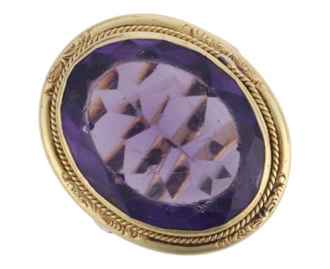 A 9ct gold and brass amethyst ring, set with oval concave-cut amethyst paste, within brass rope twist surround with 9ct ring 
