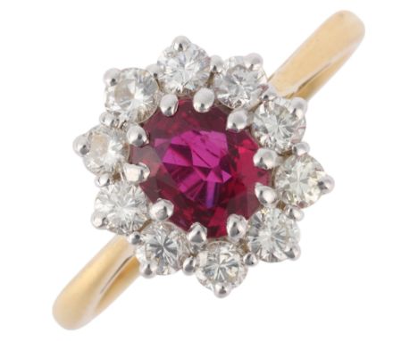 An 18ct gold ruby and diamond cluster ring, claw set with 0.85ct oval mixed-cut ruby surrounded by modern round brilliant-cut