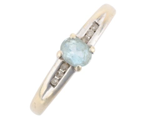 A 9ct white gold aquamarine and diamond ring, claw set with oval mixed-cut aquamarine and channel set with single-cut diamond