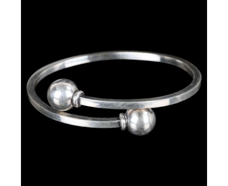 HANS HANSEN - a Danish modernist sterling silver torque bangle, model no. 207, plain form with sphere terminals, diameter 12m