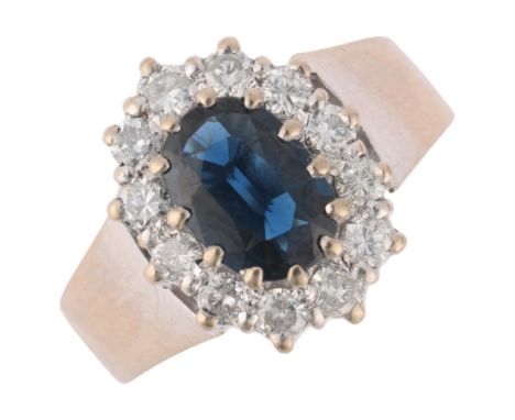 An 18ct white gold sapphire and diamond cluster ring, maker LJ, London 1976, claw set with oval mixed-cut sapphire and modern