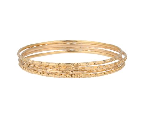 4 Middle Eastern 18ct gold slave bangles, with chased decoration, each band width 2.3mm, internal circumference 19cm, 31g tot