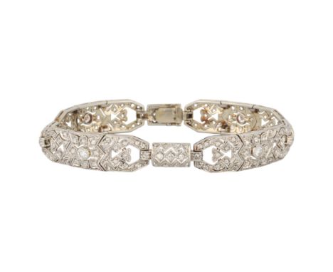 An Art Deco 18ct white gold diamond bracelet, circa 1920, of openwork geometric form, millegrain set with round transitional-