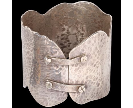 JULIE TUCKER-WILLIAMS - a large and heavy handmade sterling silver abstract bangle, London 2005, allover planished decoration