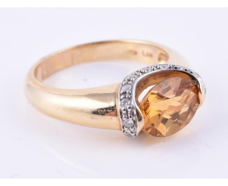 
	
		A citrine and diamond ring, the oval fancy cut citrine rub over set above a brilliant cut diamond mount, on a 14 carat y