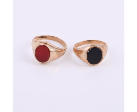 
	
		Two 9 carat gold signet rings, the first with a cornelian panel, finger size U 1/2; second with an onyx panel, finger si